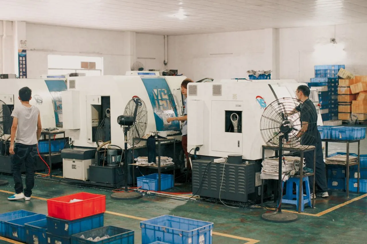 Workers operating production machinery in a factory